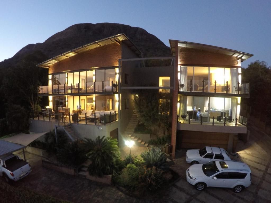 a house with a car parked in front of it at Thatch View in Hartbeespoort