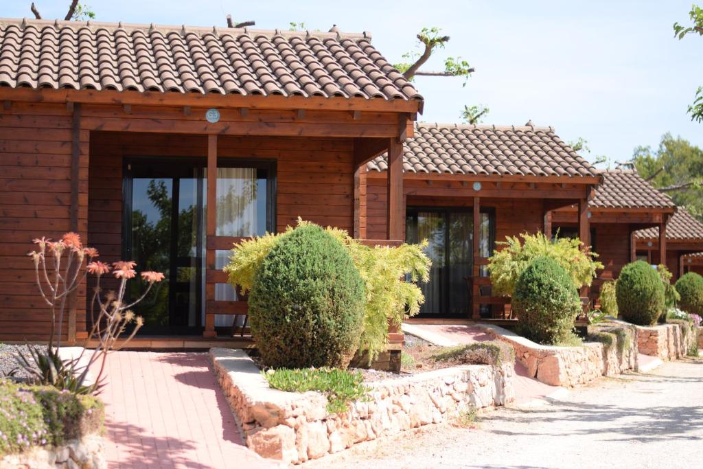 a small wooden house with a tile roof at Camping Ribamar in Alcossebre