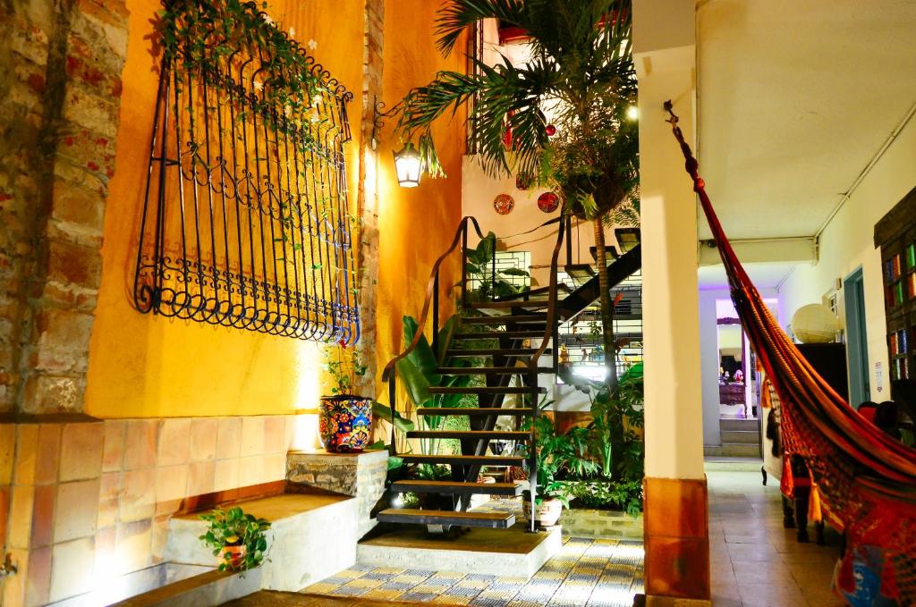 a lobby with a spiral staircase in a building at Magic Garden House in Cali