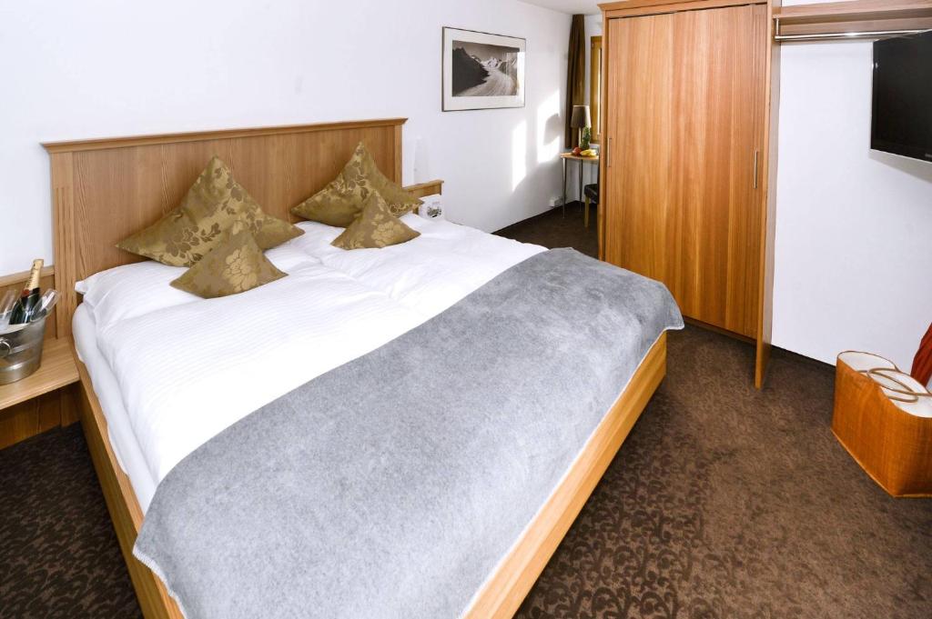 Postel nebo postele na pokoji v ubytování Hotel Alpina