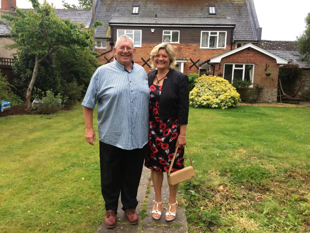 a man and a woman standing in front of a house at Cowes - The Barn in Cowes