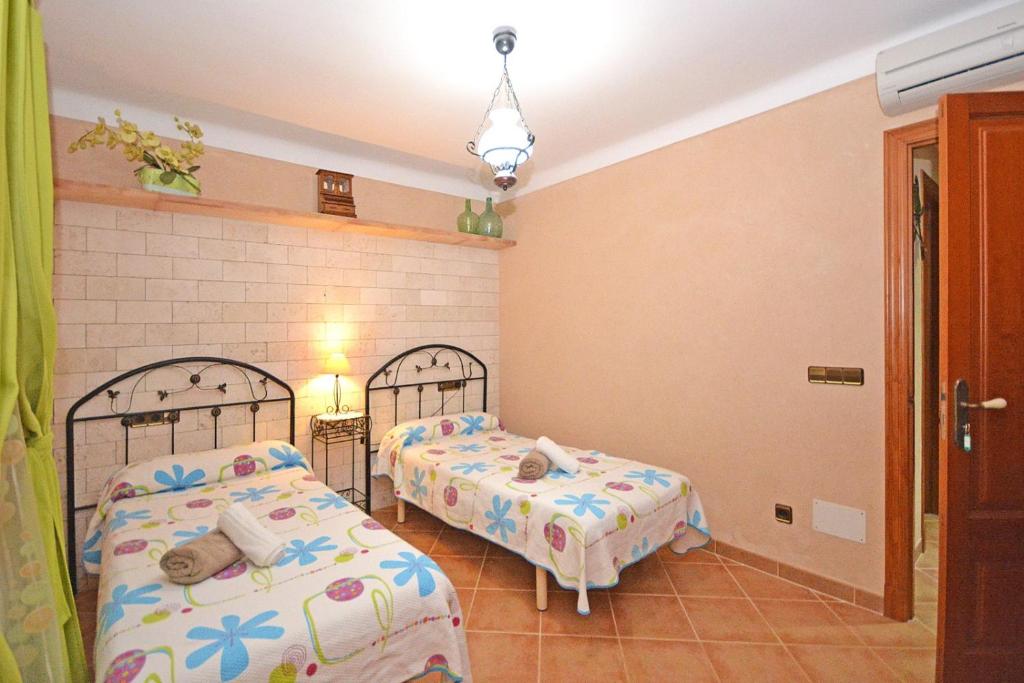 Postel nebo postele na pokoji v ubytování Villa Gamundi