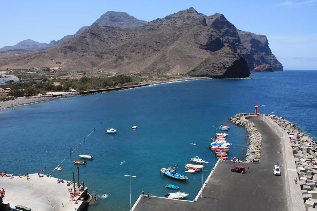 a group of boats in a body of water at Apartments Playa La Aldea in Las Marciegas