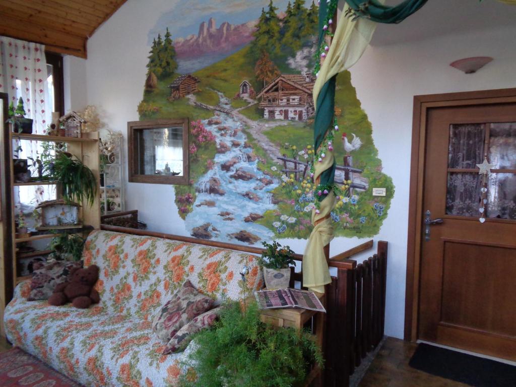 un canapé dans une pièce avec un tableau mural dans l'établissement Casa Noemi Imer, à Imer