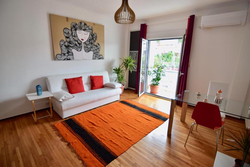 a living room with a white couch and a glass table at Athens central apartment with Acropolis views! - SQ1 in Athens