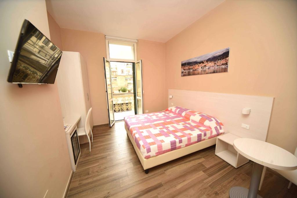 a small bedroom with a bed and a window at Gioberti House in Sanremo