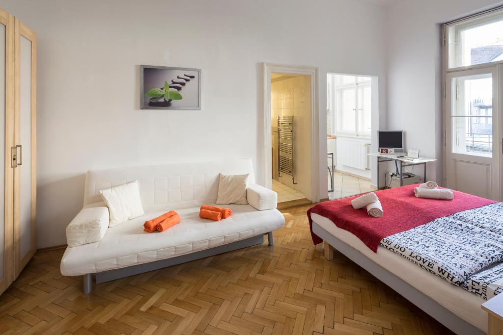 a living room with a couch and a bed at Dušní Apartments in Prague