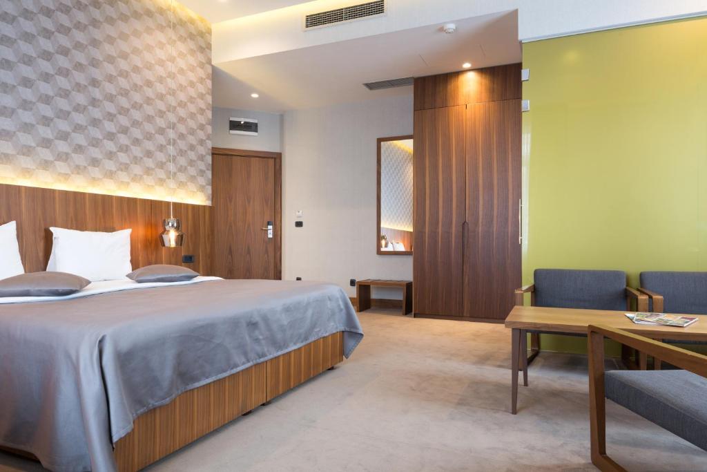 a hotel room with a bed and a desk at Five Points Square - City Center in Belgrade