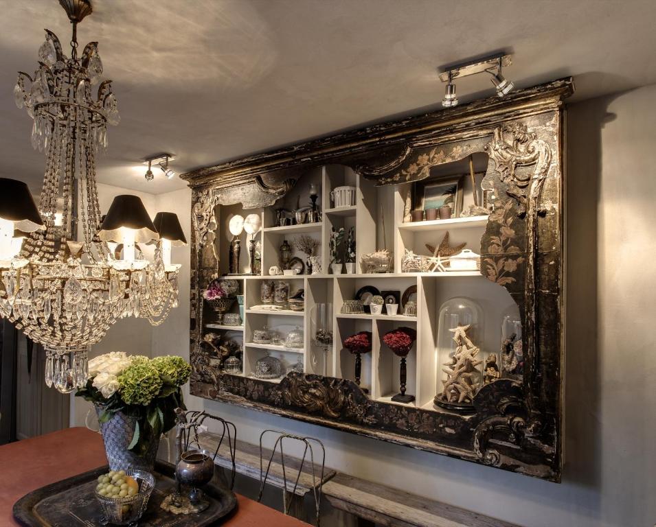 a large mirror on the wall in a dining room at Maison de charme Pampelonne Saint Tropez in Saint-Tropez