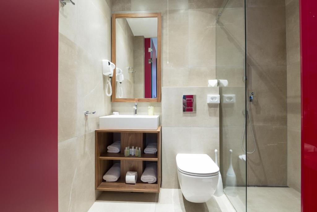 a bathroom with a toilet and a sink and a shower at Five Points Square - City Center in Belgrade