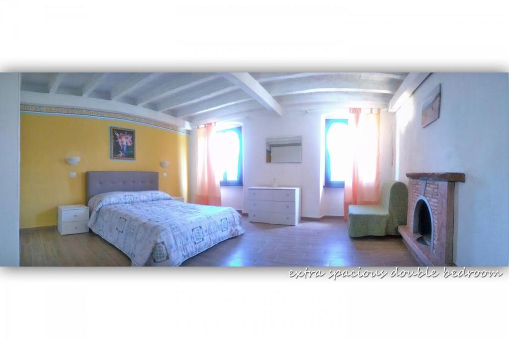 A bed or beds in a room at Appartamenti La Tartufaia Country house pool and relax By Gardadomusmea