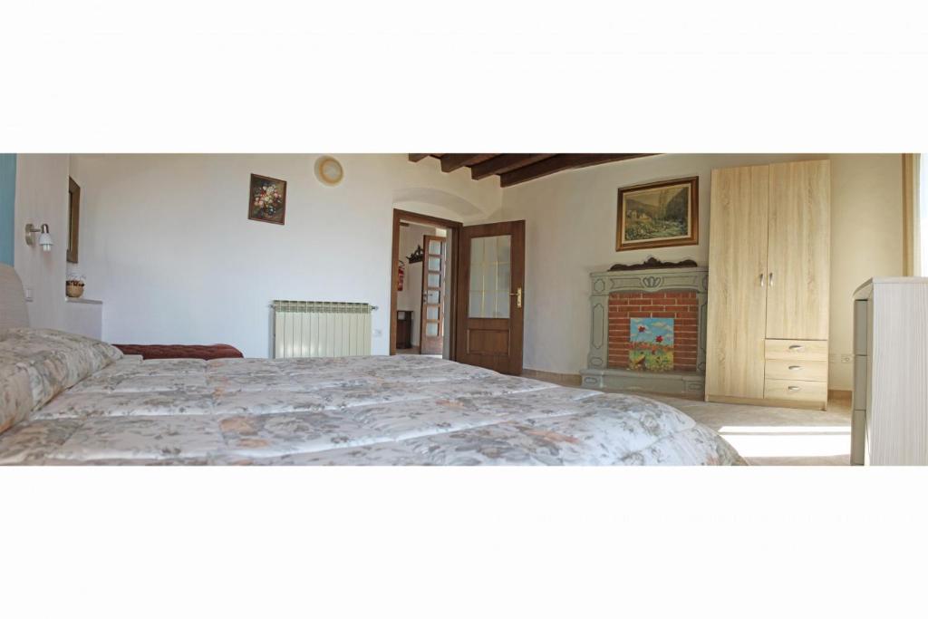 A bed or beds in a room at Appartamenti La Tartufaia Country house pool and relax By Gardadomusmea