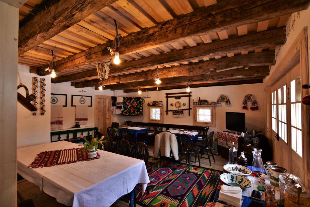 a dining room with tables and chairs in a building at Iz de Maramures Rural Hotel in Şurdeşti