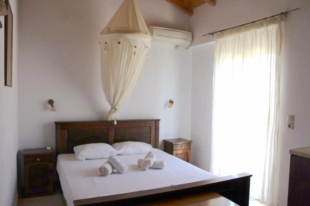 a bedroom with a bed with towels on it at Avra Studios in Elafonisos