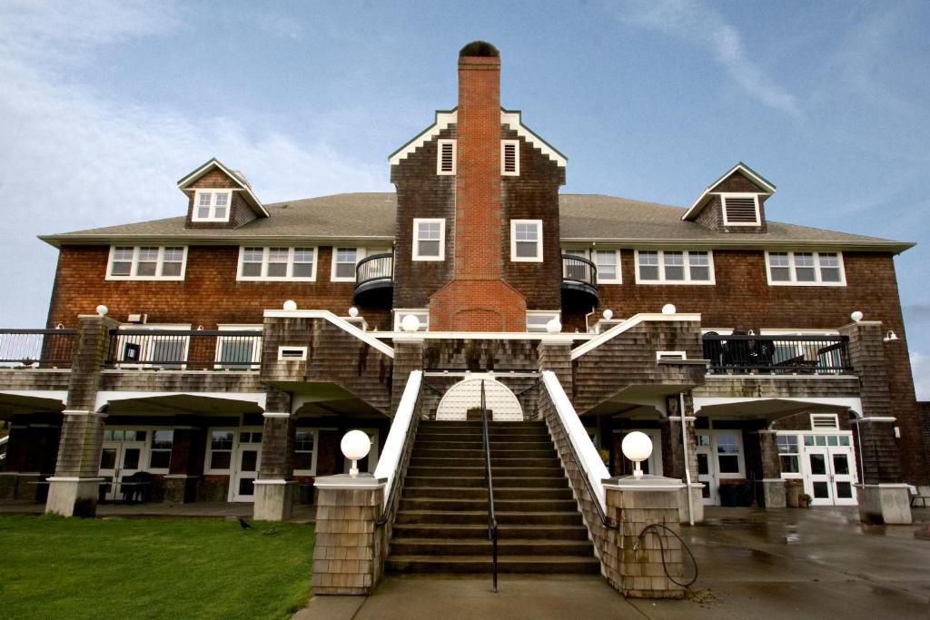 a large brick building with stairs leading up to it at McMenamins Gearhart Hotel in Gearhart