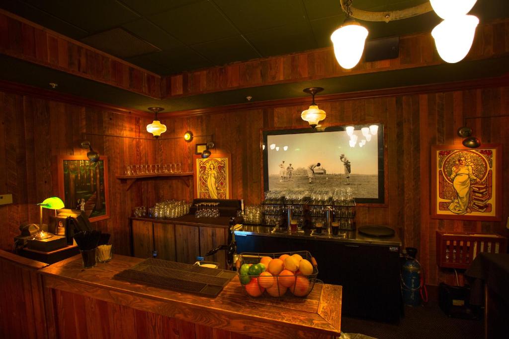 a bar in a pub with a television on the wall at McMenamins Gearhart Hotel in Gearhart