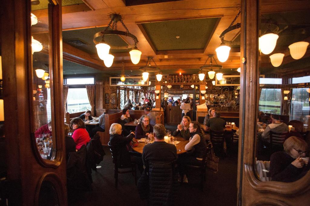 a group of people sitting at tables in a restaurant at McMenamins Gearhart Hotel in Gearhart