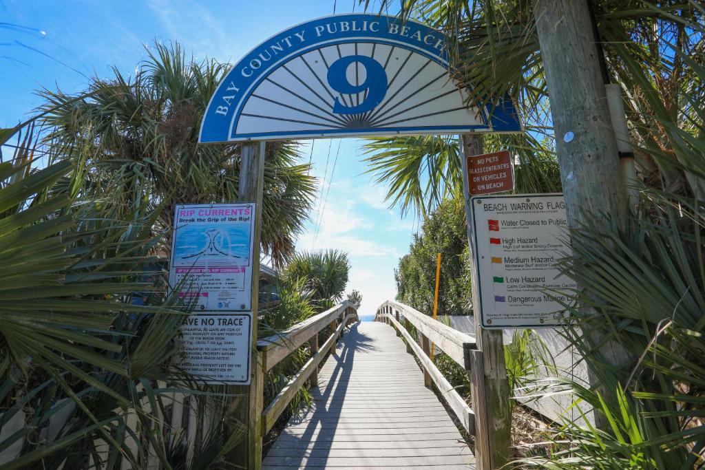 a sign for a boardwalk on a beach with a bridge at House 3 blocks to the beach in Panama City Beach