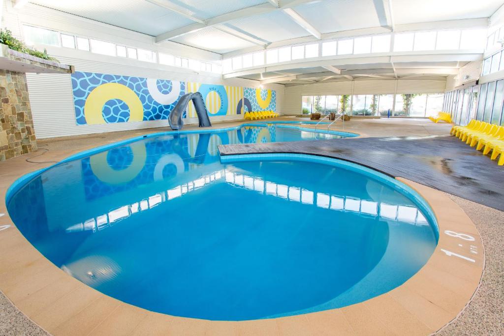 
a swimming pool with a pool table and chairs at BIG4 Anglesea Holiday Park in Anglesea
