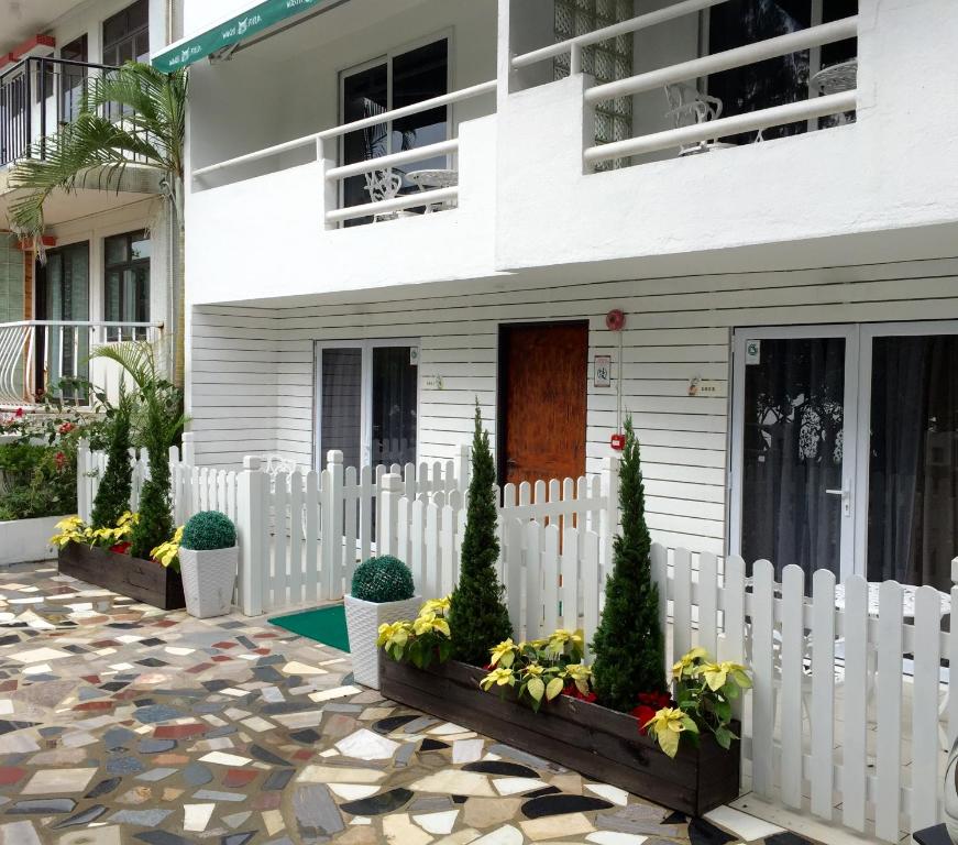 a white fence in front of a house at Bellagio Pets Friendly Resort in Hong Kong