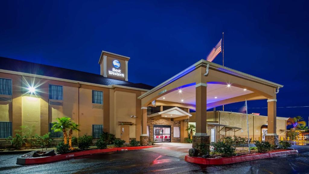 a hotel with an american flag on top of it at Best Western Casino Inn in Vinton