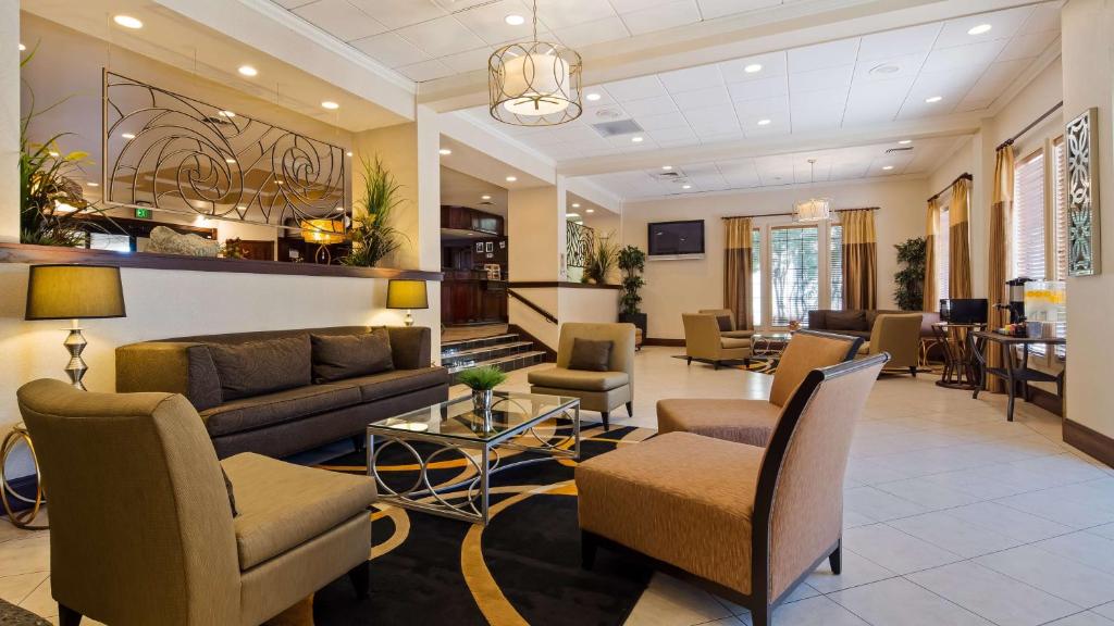 a living room with couches and chairs at Hotel Bridgeway Tucson Int'l Airport and Suites in Tucson