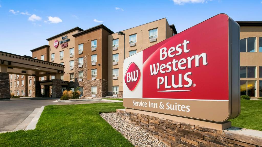 a red and white sign on the side of a building at Best Western Plus Service Inn & Suites in Lethbridge