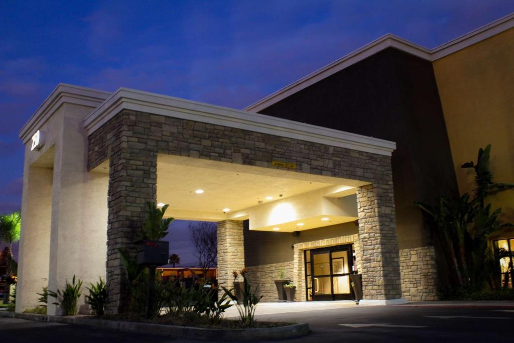 a large building with a lit up entrance at Best Western Plus Arrowhead Hotel in Colton