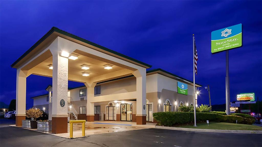 a hotel building with a sign in front of it at SureStay Hotel by Best Western Sonora in Sonora