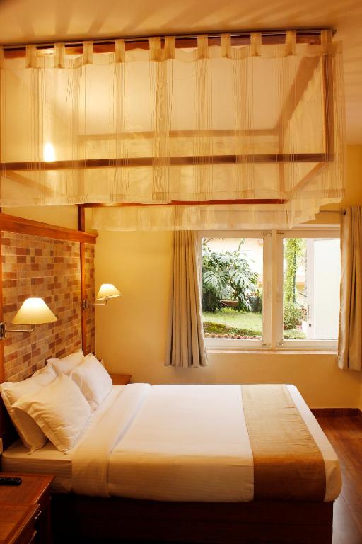Postel nebo postele na pokoji v ubytování Kodai Resort Hotel, Kodaikanal