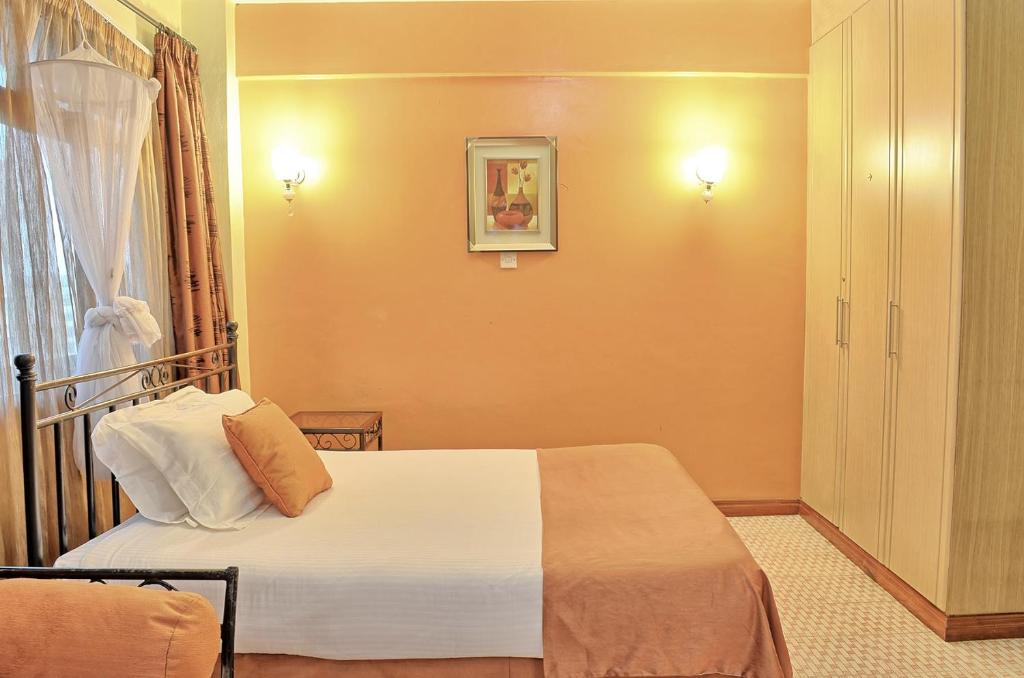 Postel nebo postele na pokoji v ubytování Space International Hotel