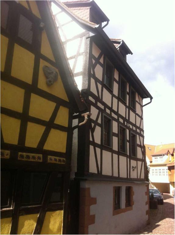 a yellow and white building with ahalf timbered at Ferienhaus Gloecknerhaus in Michelstadt