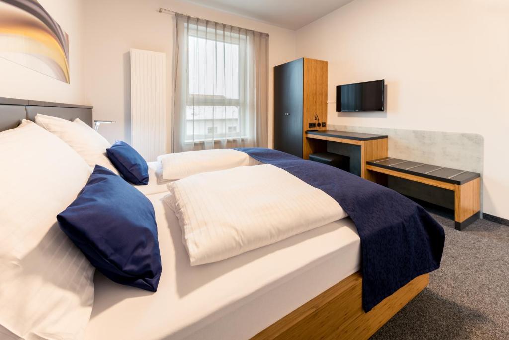 Postel nebo postele na pokoji v ubytování Motel Grieskirchen superior