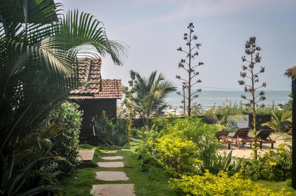 een pad naar een resort met de oceaan op de achtergrond bij Lotus Sutra in Arambol
