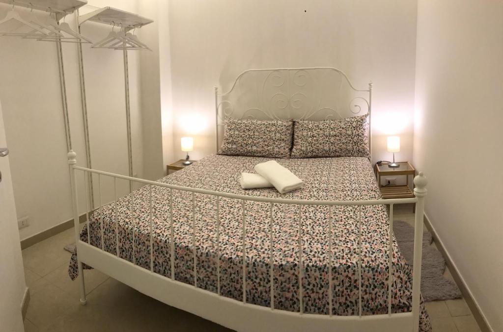 a bedroom with a metal bed with two lamps at B&B Bari Old Town in Bari