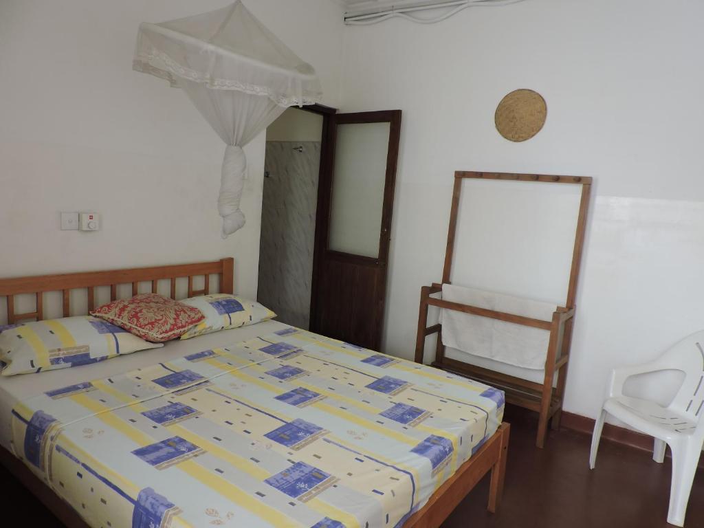 Postel nebo postele na pokoji v ubytování Hotel Mango Garden