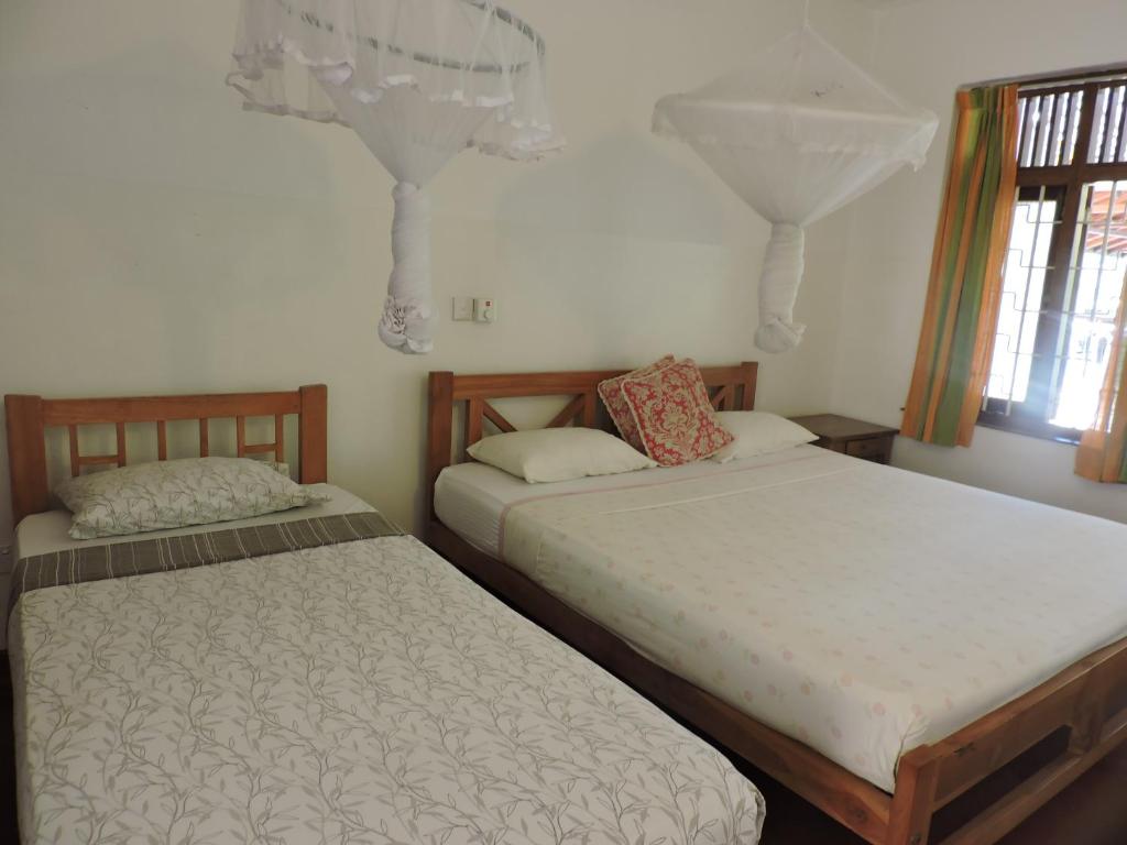 Postel nebo postele na pokoji v ubytování Hotel Mango Garden