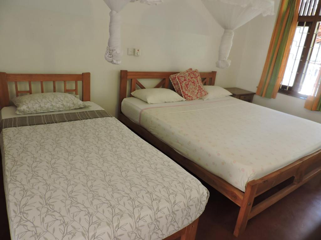 Postel nebo postele na pokoji v ubytování Hotel Mango Garden