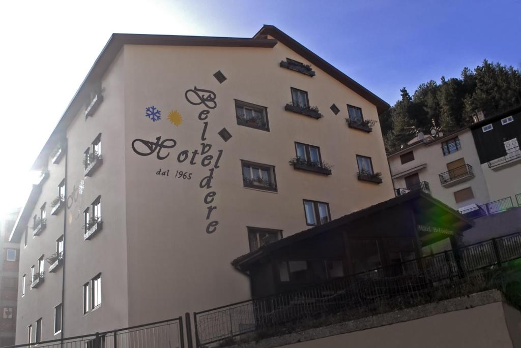 a building with a sign on the side of it at Hotel Belvedere in Roccaraso