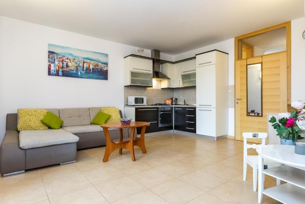 a living room with a couch and a table at Maru Apartments in Novalja