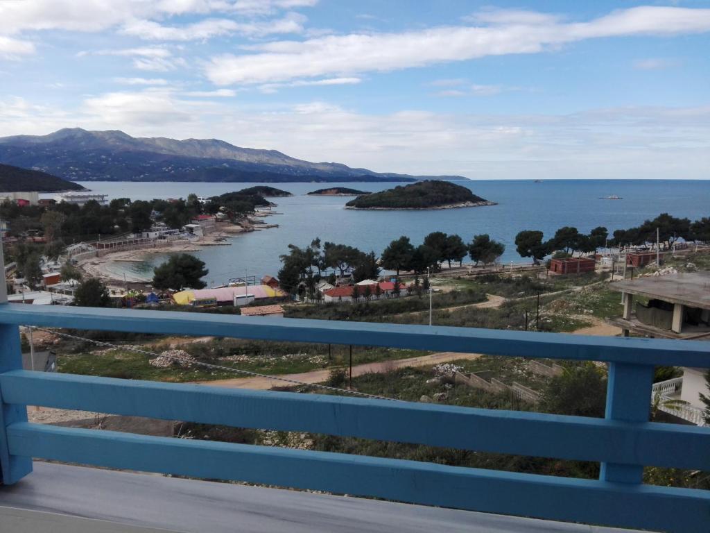 a view of a body of water with a blue railing at Vip Apartment by "Murati" in Ksamil