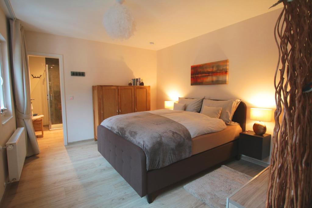 a bedroom with a large bed with two lamps at Haus am Stadtturm in Traben-Trarbach