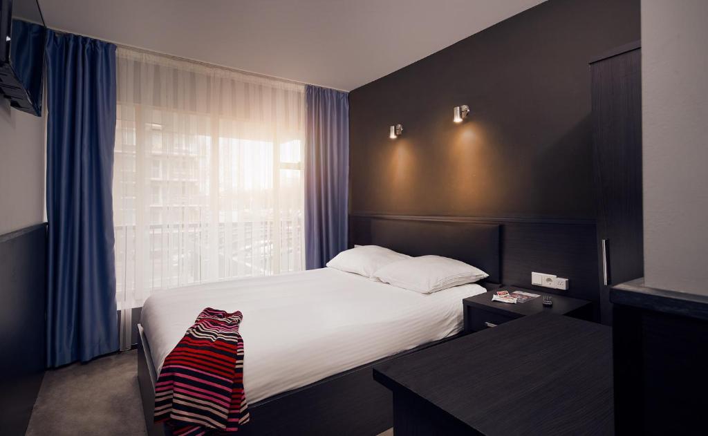 Postel nebo postele na pokoji v ubytování Belfort Hotel