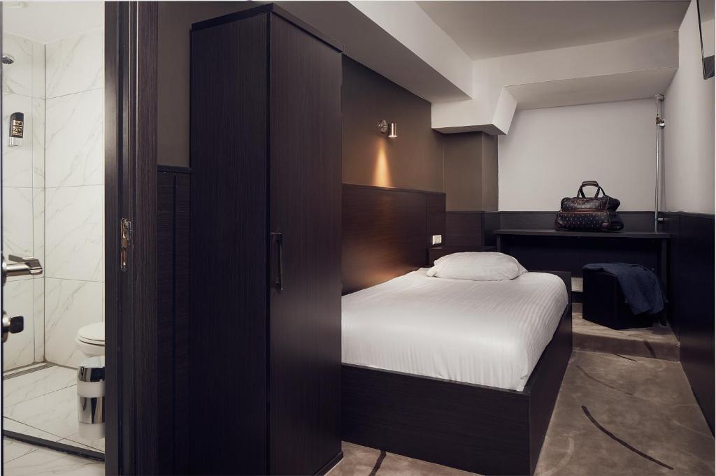 Postel nebo postele na pokoji v ubytování Belfort Hotel
