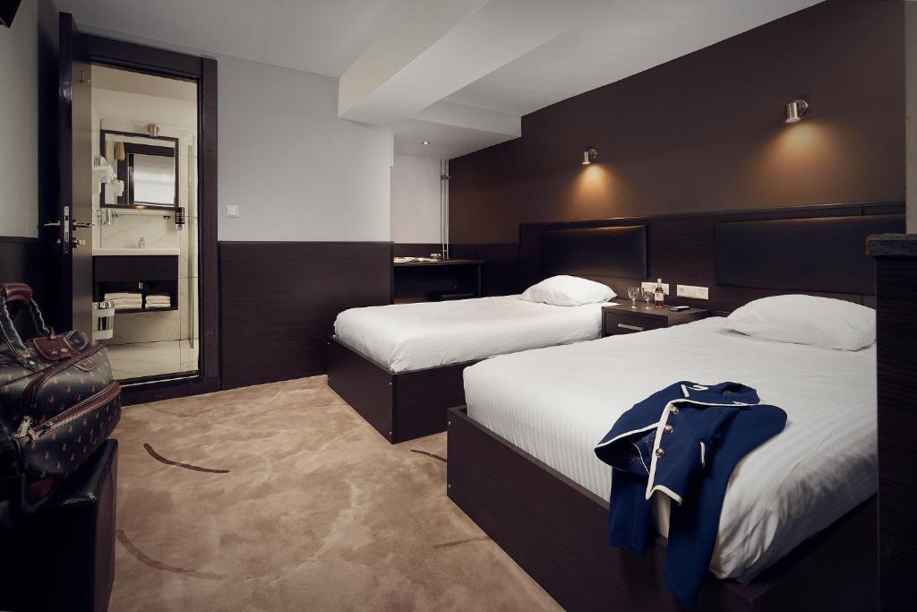Postel nebo postele na pokoji v ubytování Belfort Hotel
