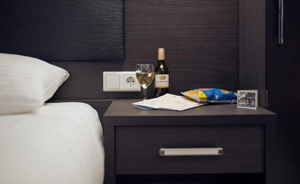 Postel nebo postele na pokoji v ubytování Belfort Hotel