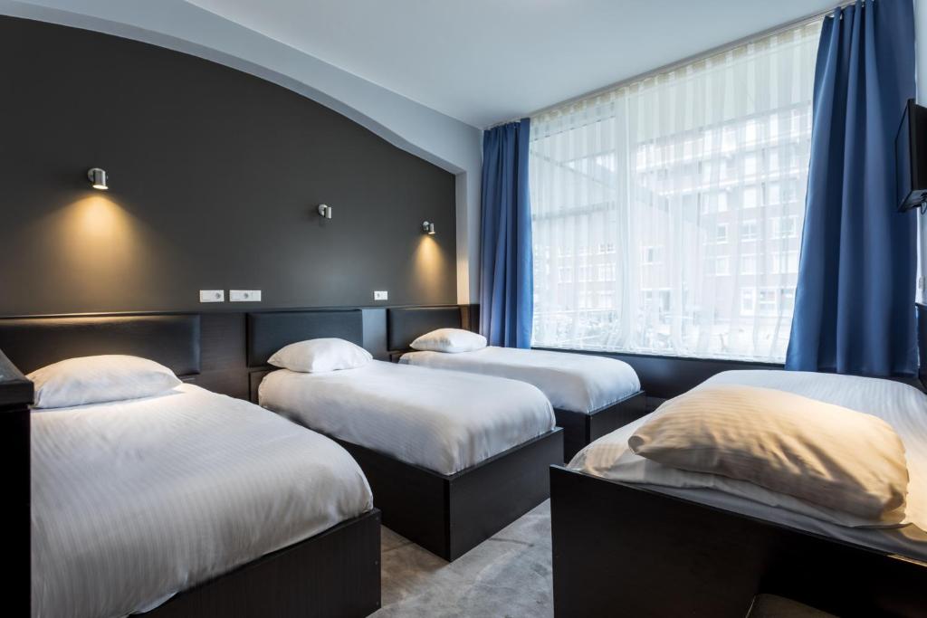 Postel nebo postele na pokoji v ubytování Belfort Hotel