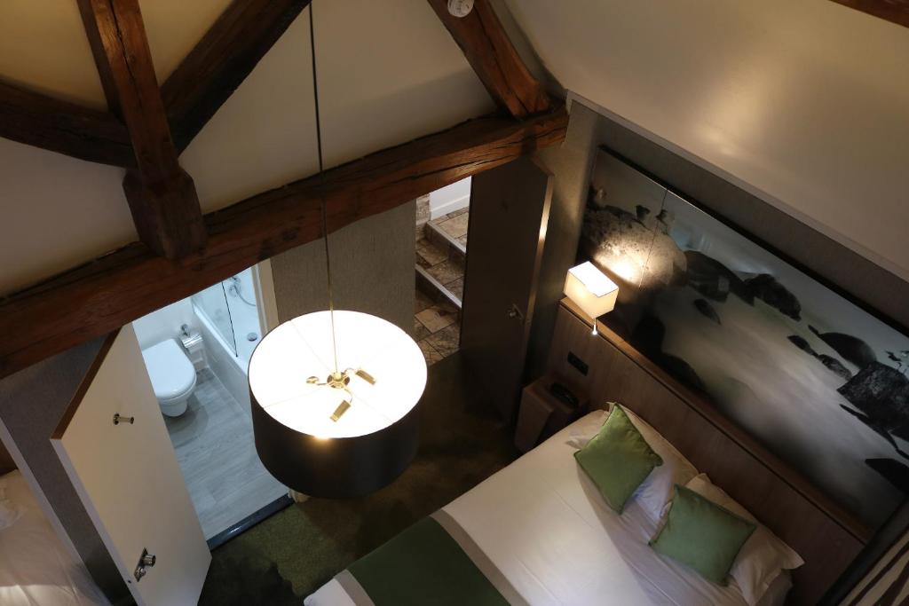 an overhead view of a room with a bed and a table at Le Mouton Blanc in Le Mont Saint Michel