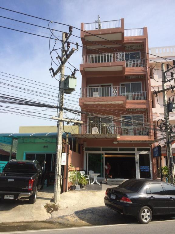two cars parked in front of a building at Naithon Beach Residence in Nai Thon Beach