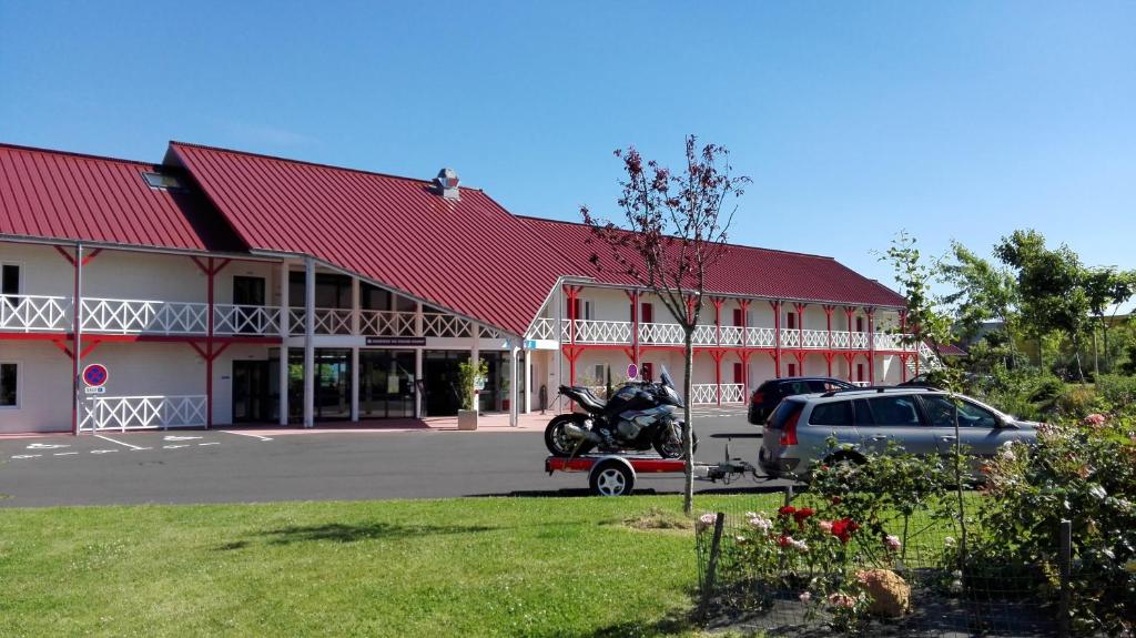 a motorcycle parked in front of a building at Fasthotel Montmarault in Montmarault